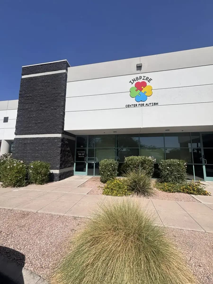 The Inspire Center for Autism building on East Southern Avenue in Mesa, Arizona, with the puzzle-flower logo on the facade